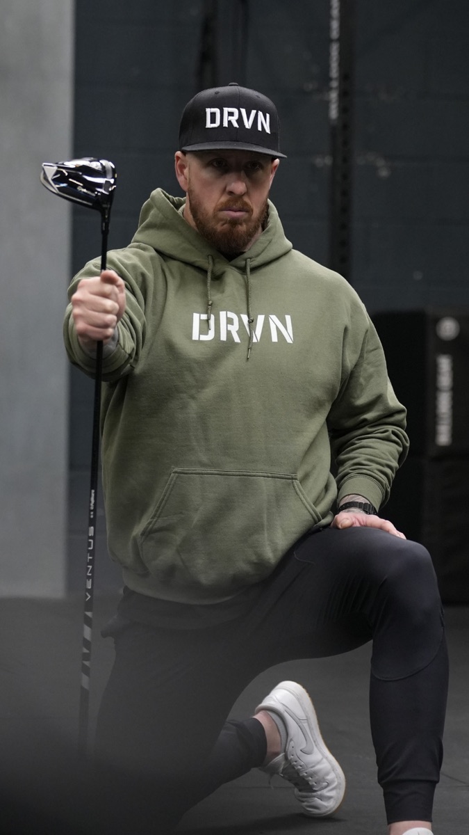 Michael in DRVN gear with a golf club